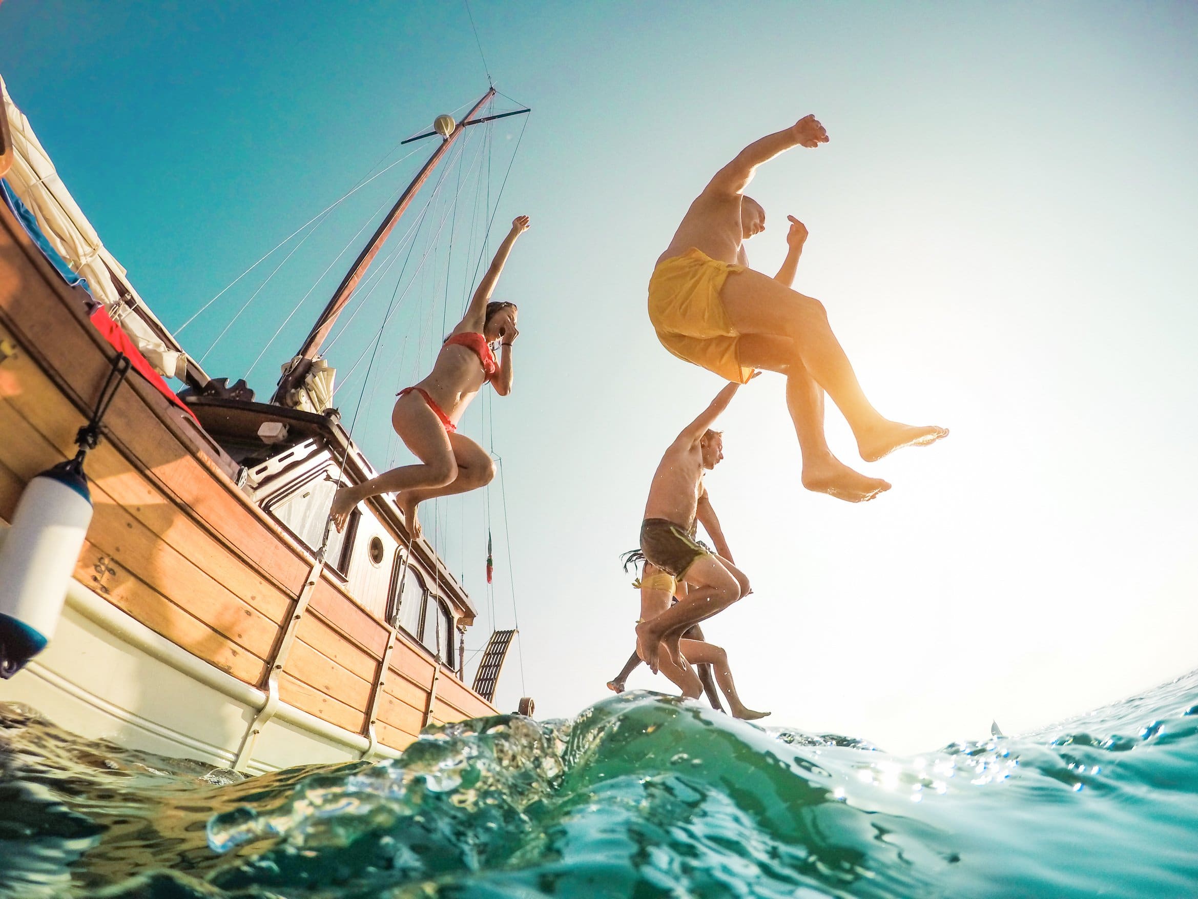 boat rentals malta boatcare trading malta. adults jumping from boat to sea