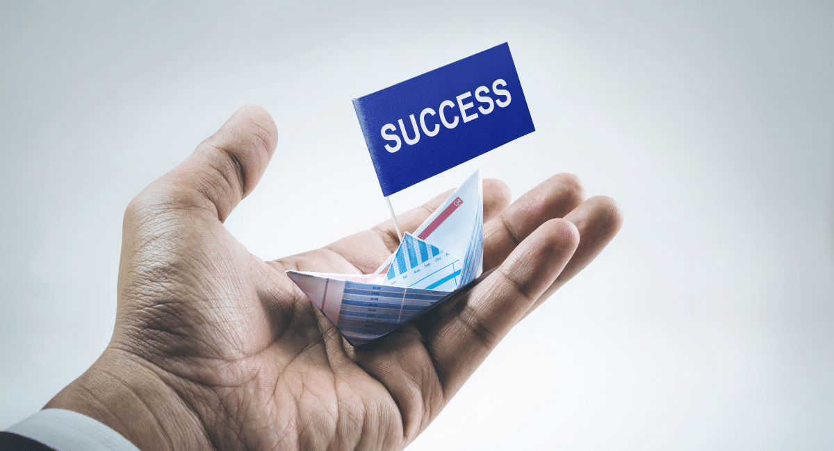 boat brokers boatcare trading limited malta. Boat on man's hand with success flag